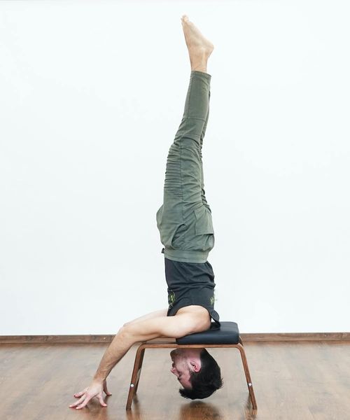 Man practicing strength exercises in a minimalist room